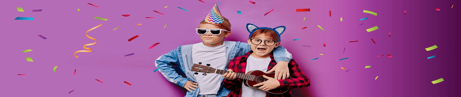 two pre teenagers celebrating a birthday and playing guitar
