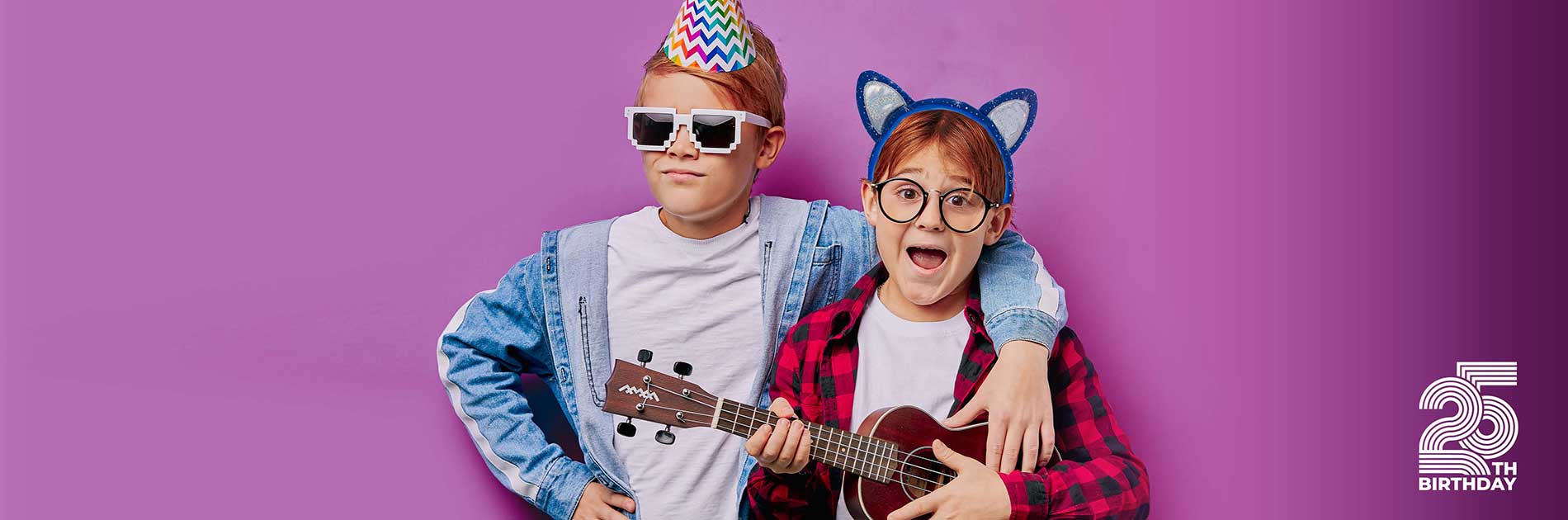 two pre teenagers celebrating a birthday and playing guitar