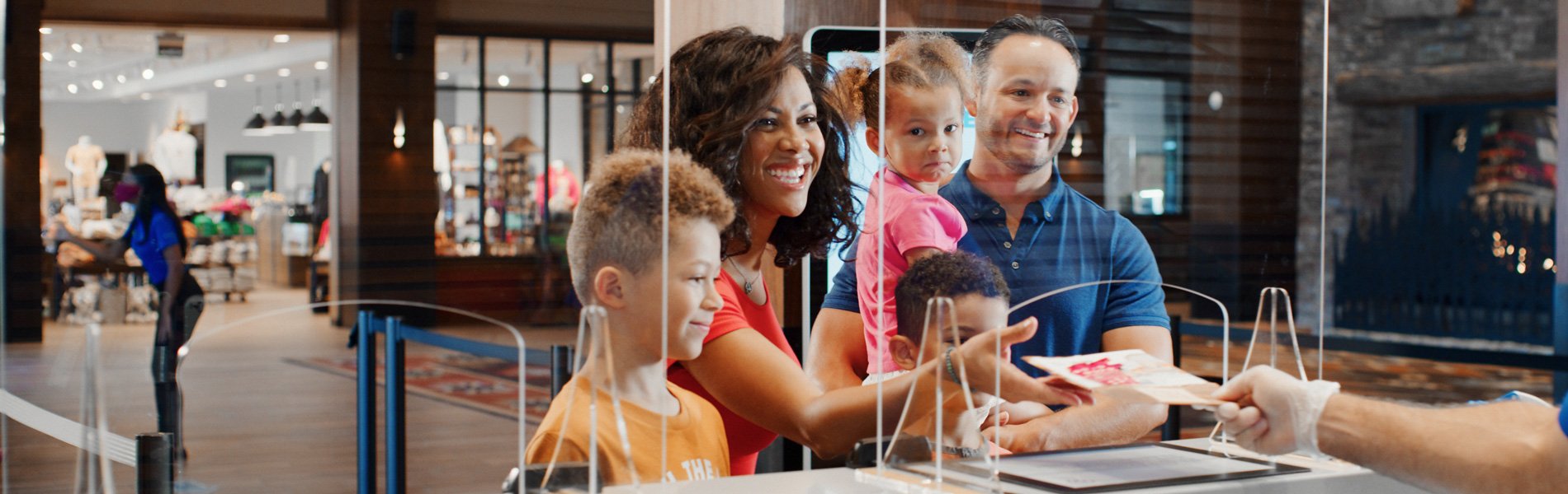 Family smiling while checking in at Great Wolf Lodge