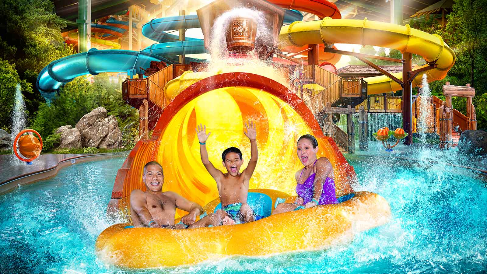 A family of three having fun on a raft water slide