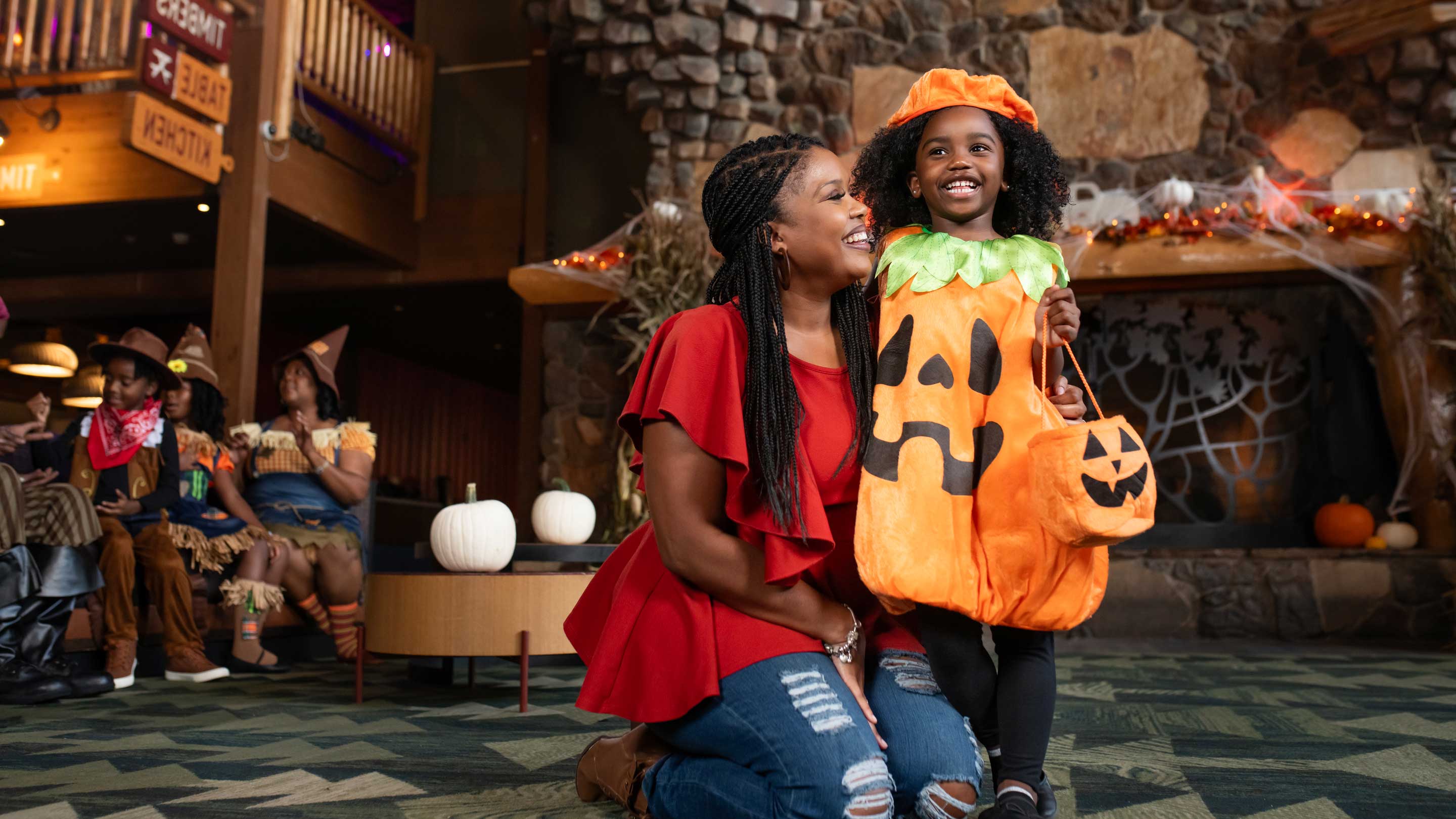 mother and daughter wearing a halloween costume pose for a photo