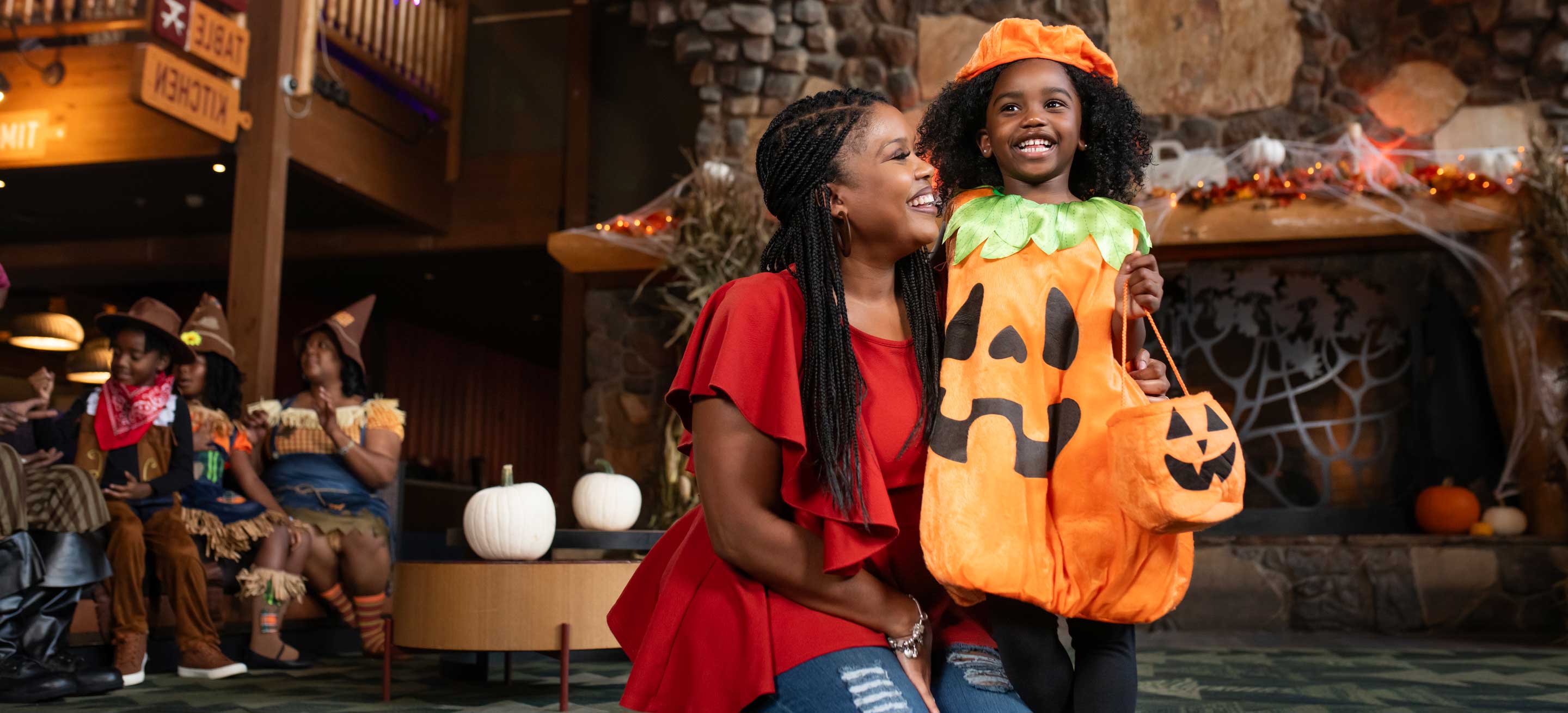 mother and daughter wearing a halloween costume pose for a photo