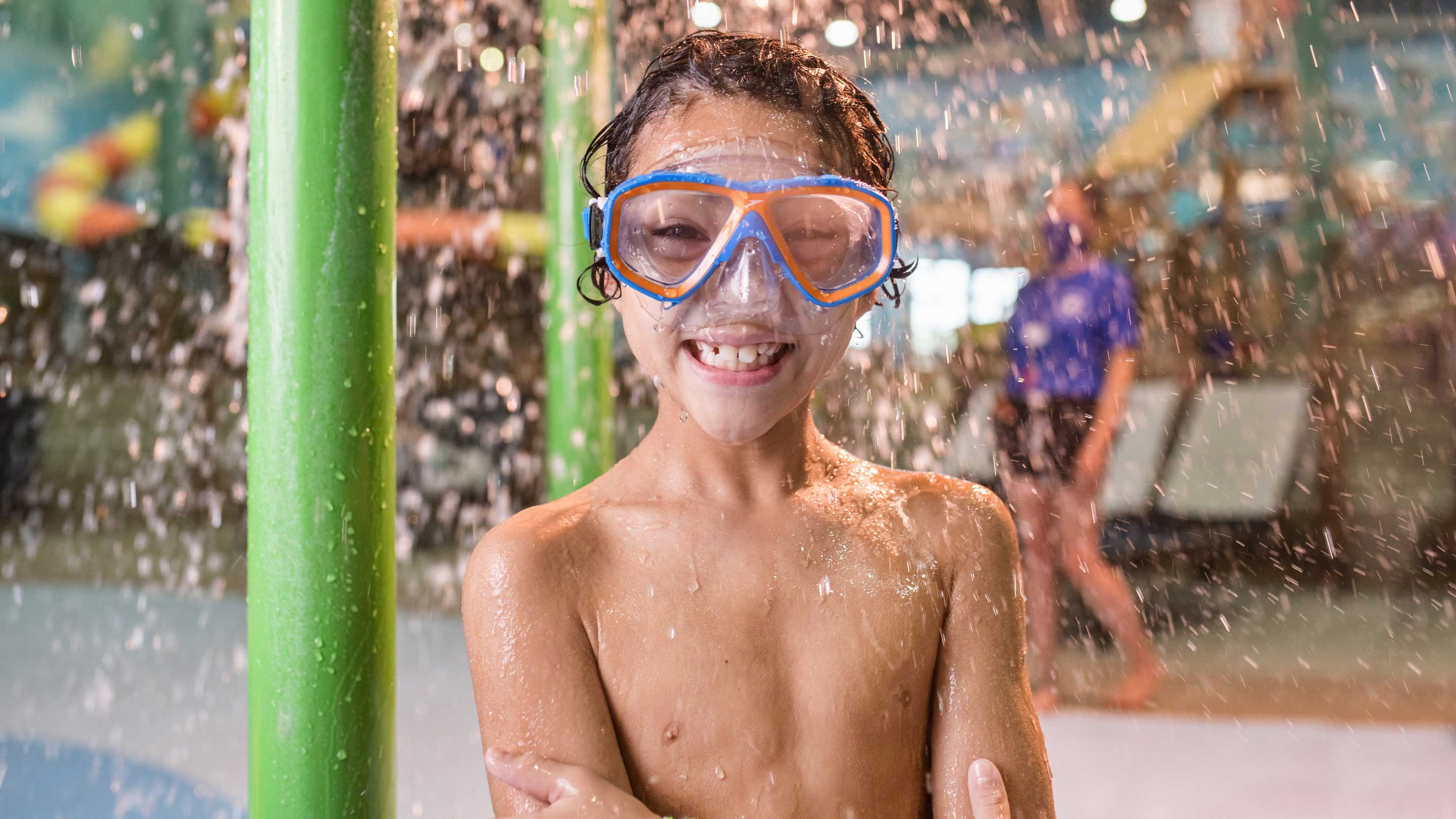boy wearing swimming glasses and smiling