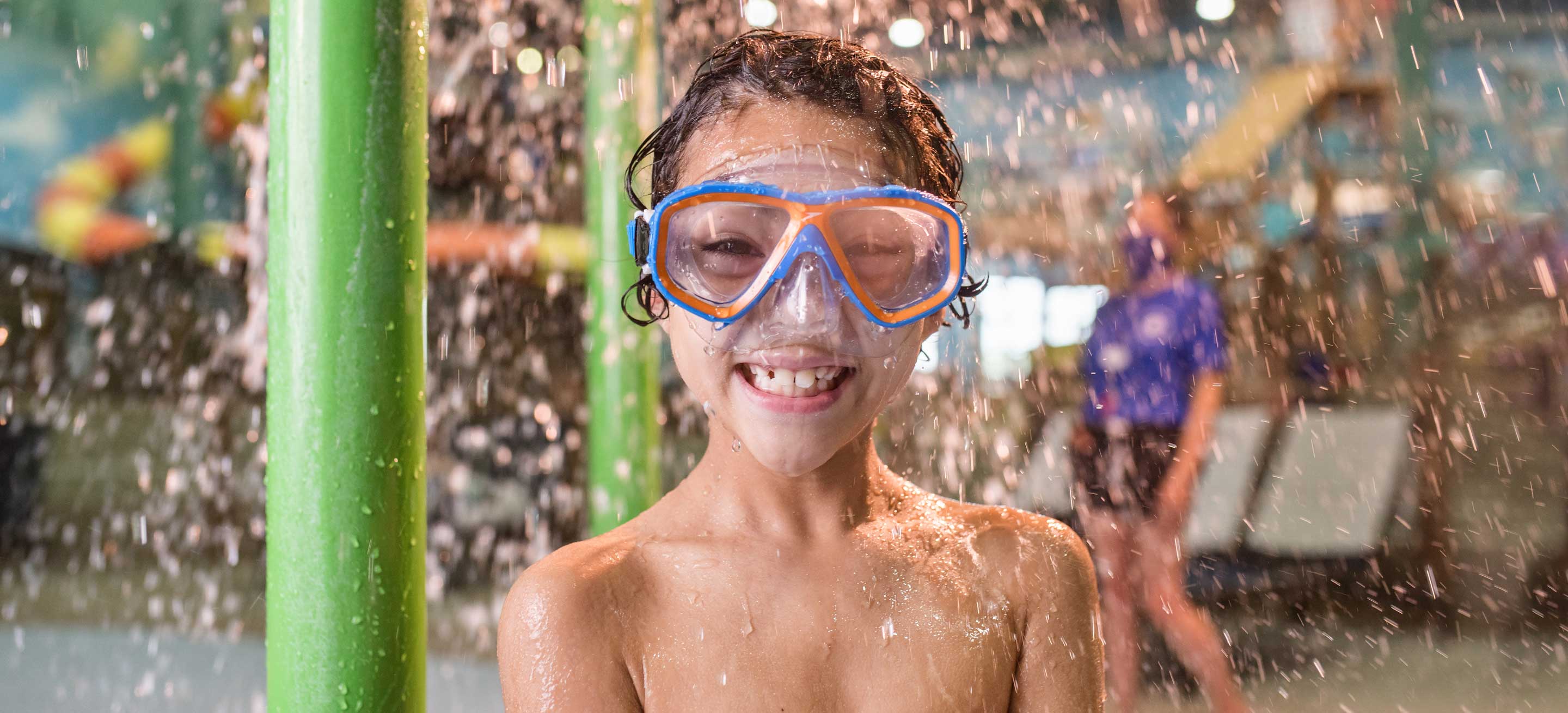 boy wearing swimming glasses and smiling