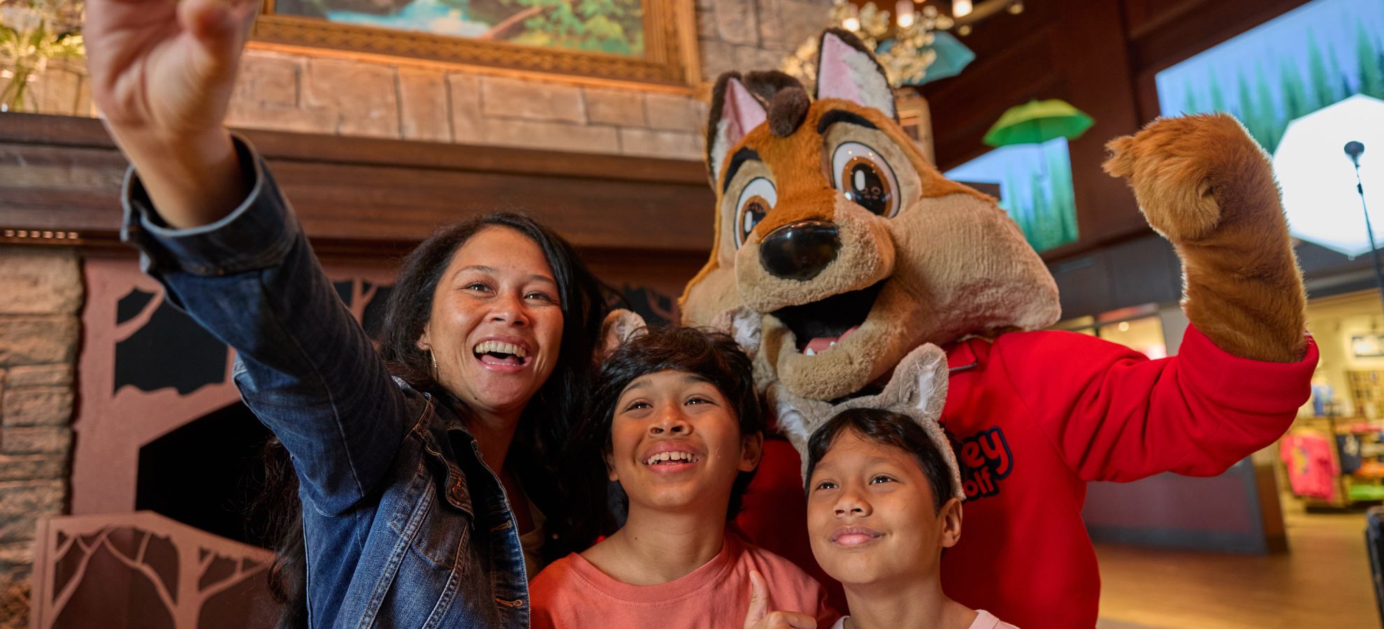  Mom and two children taking a selfie with Wiley the Wolf.