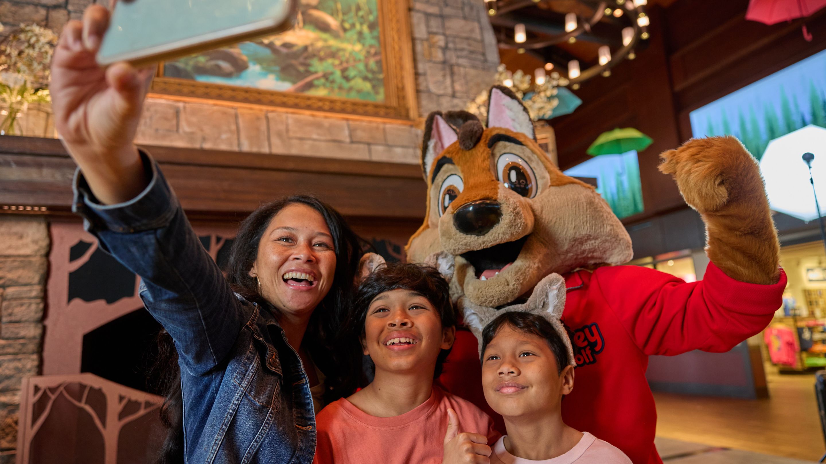  Mom and two children taking a selfie with Wiley the Wolf.