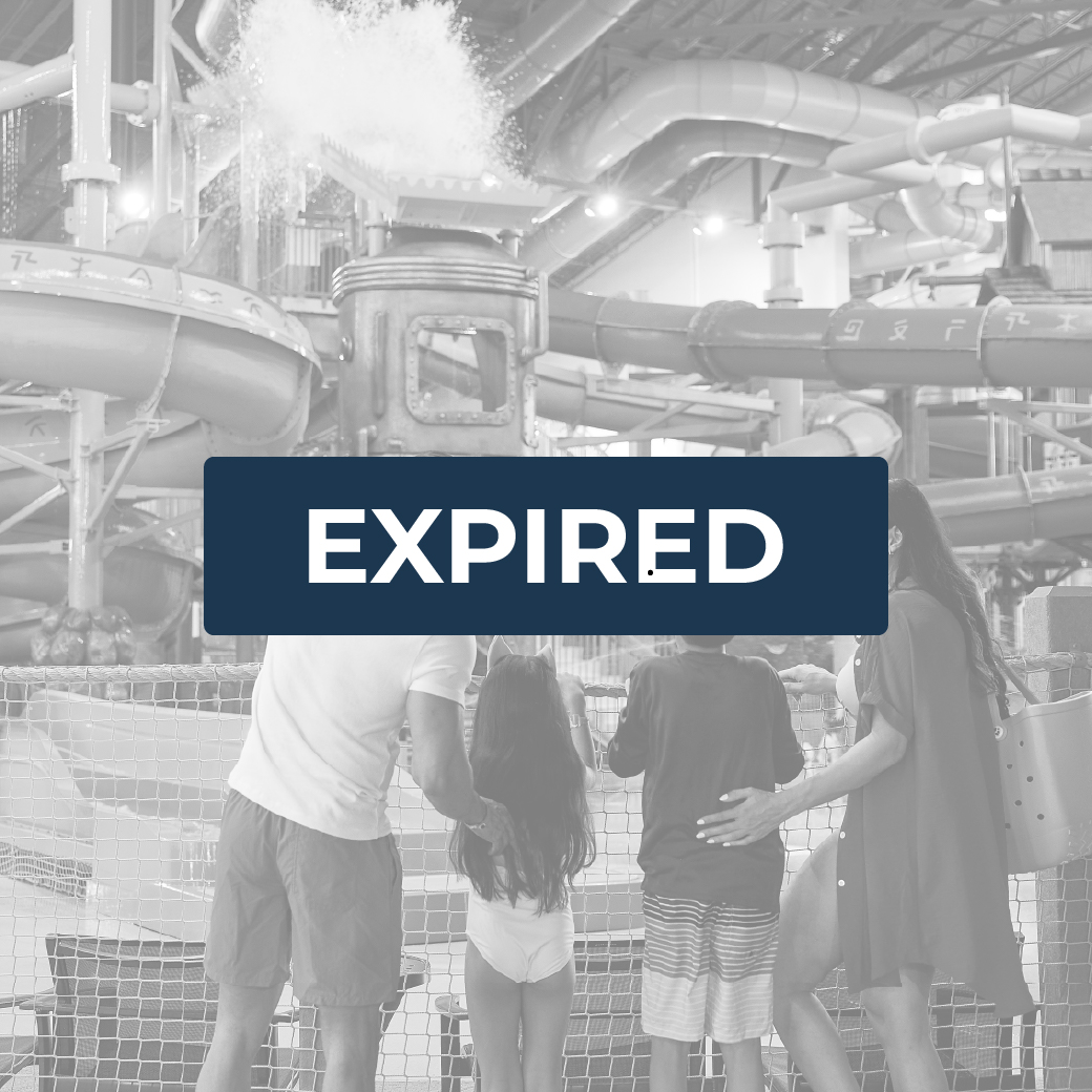 family enjoying water dropping from a big bucket at a waterpark