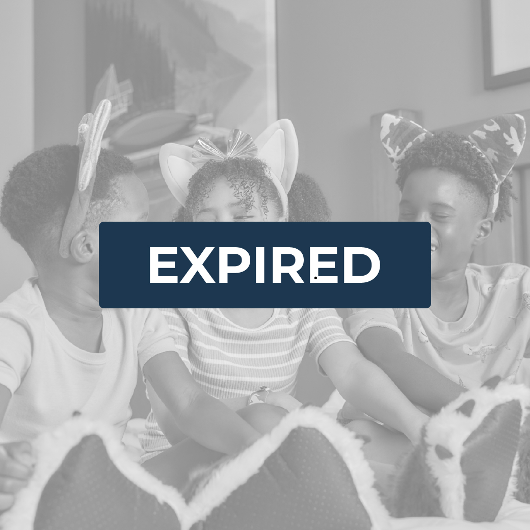 kids sitting on a bed in a hotel and laughing