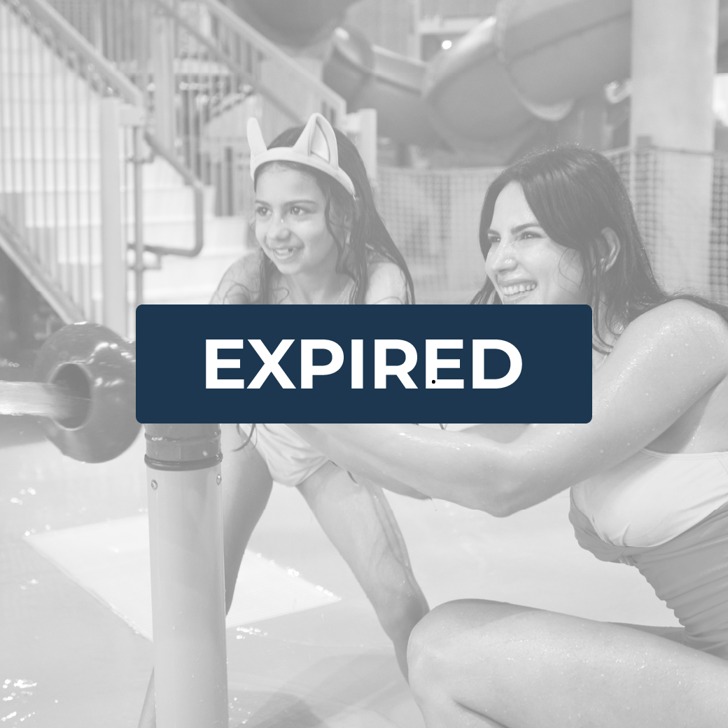 mother and daughter laughing as they play with a water gun at the waterpark
