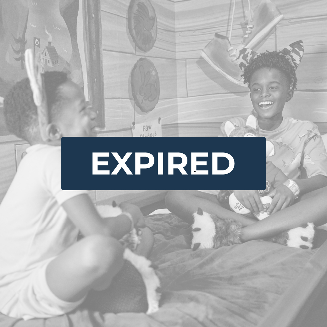 two boys wearing wolf ears sitting on a bunk bed and smiling