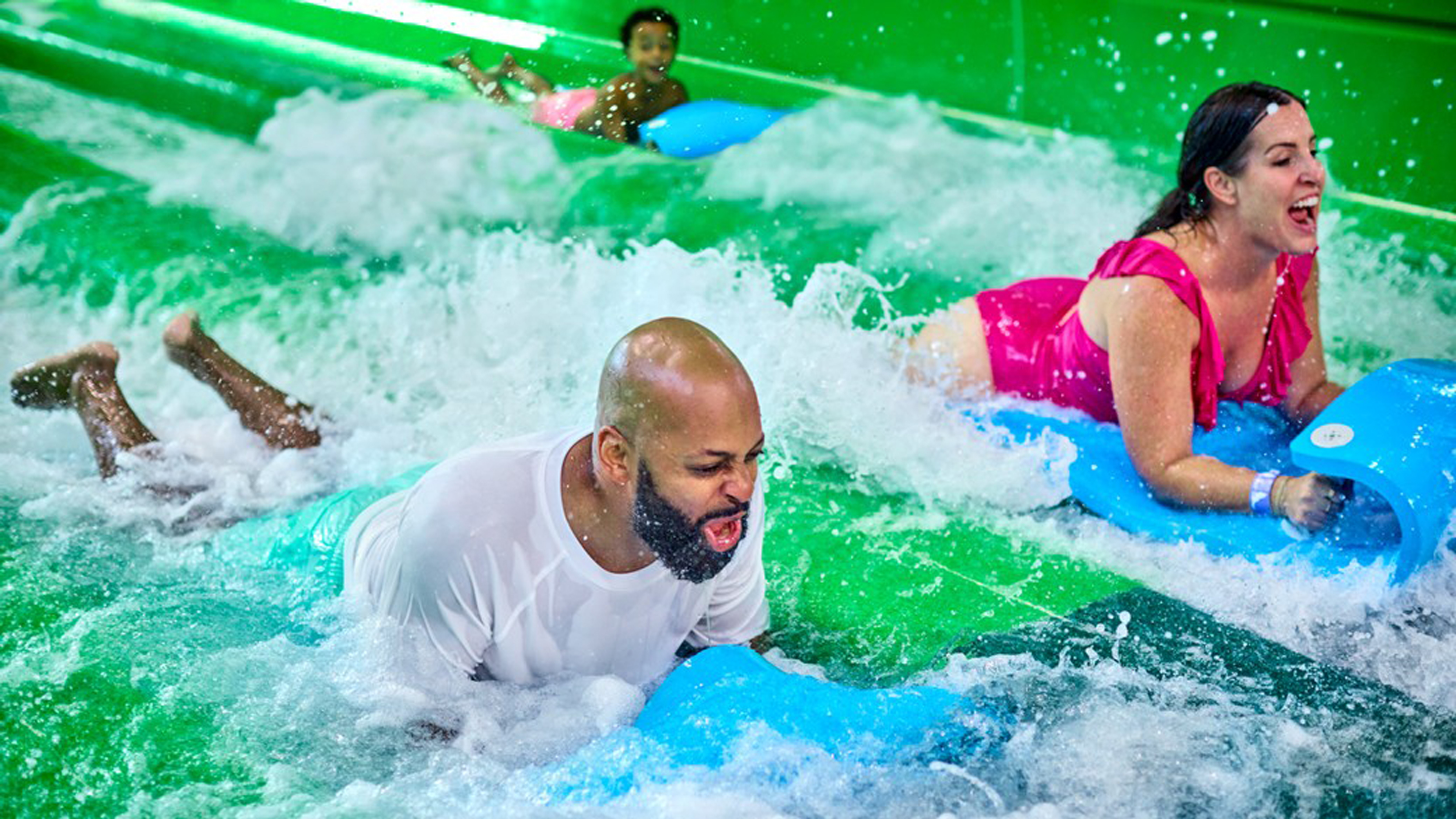 Parents sliding on a water slide at Great Wolf Lodge