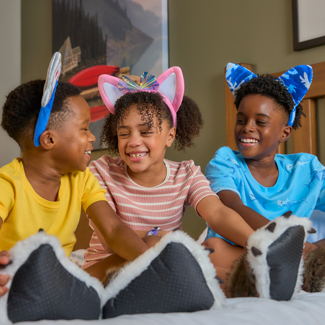 three kids wearing wolf ears and laughing 
