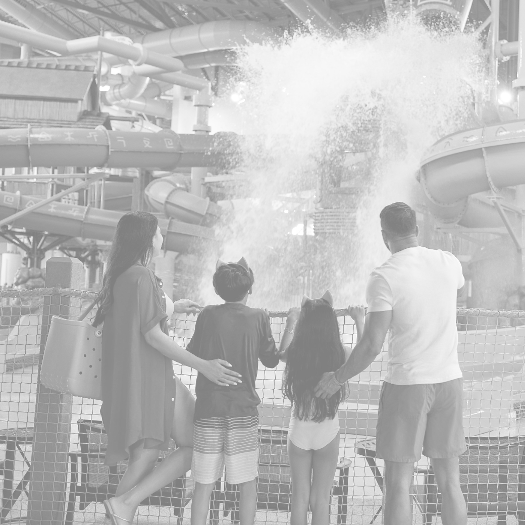 family looks at a bucket splashing water