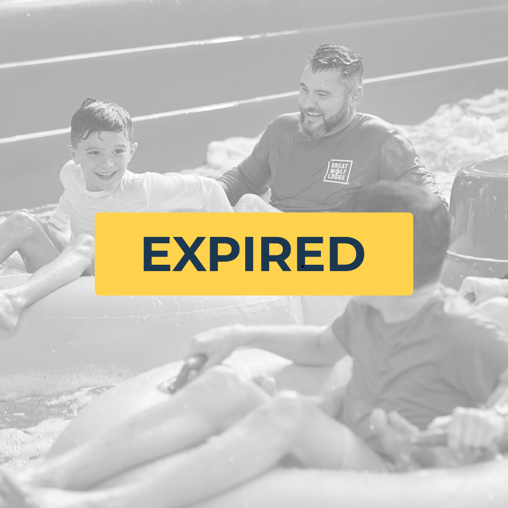 father and son riding tubes on a water slide