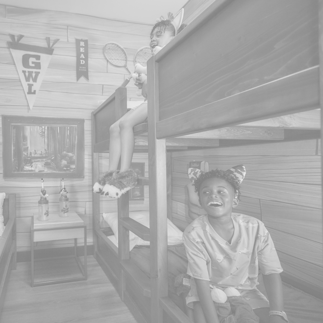 kids sitting on bunk beds in a theamed room