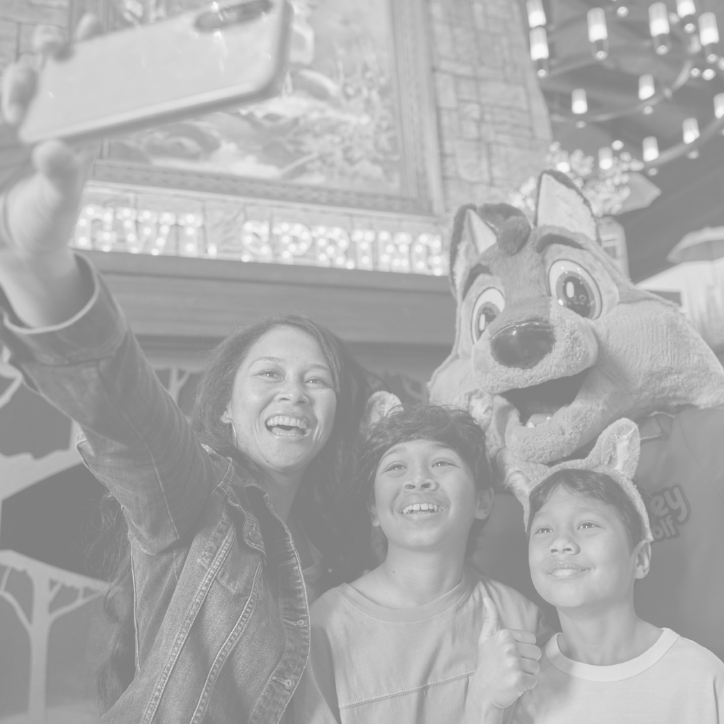 mother and kids taking a selfie with a wolf character