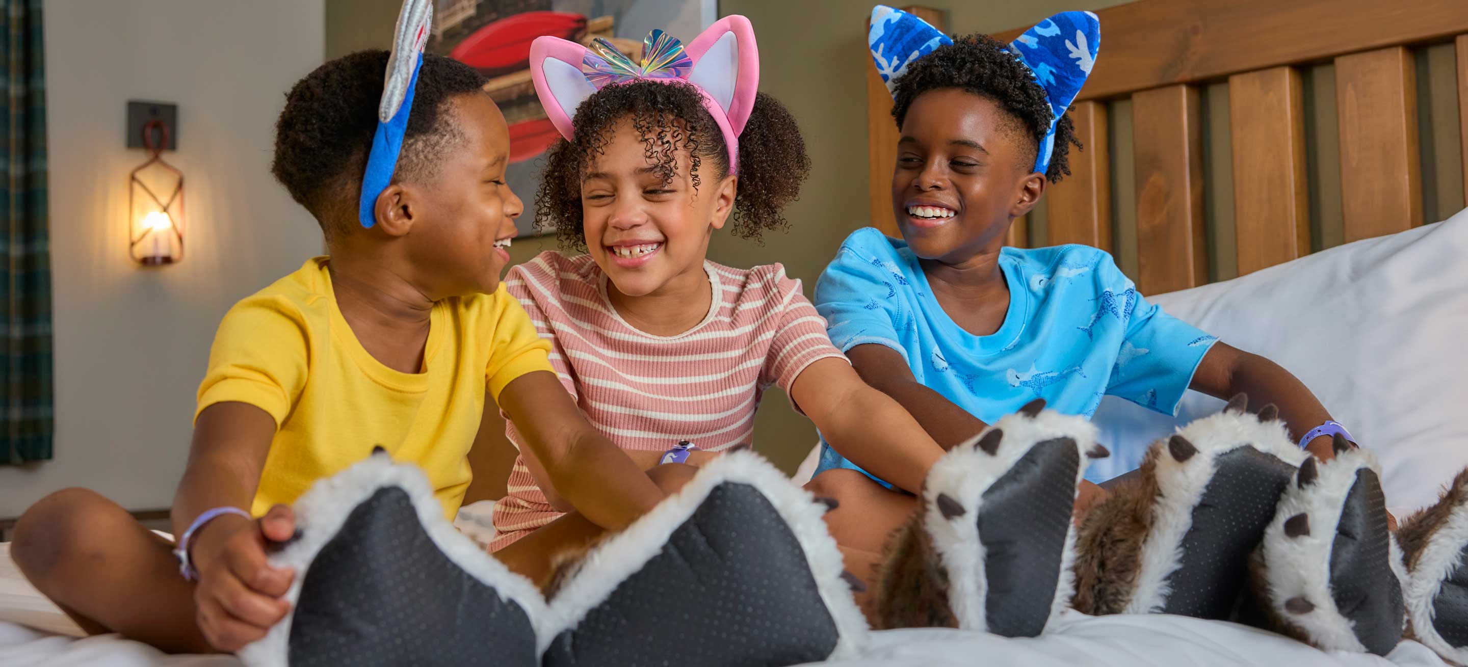 kids sitting on bed and smiling