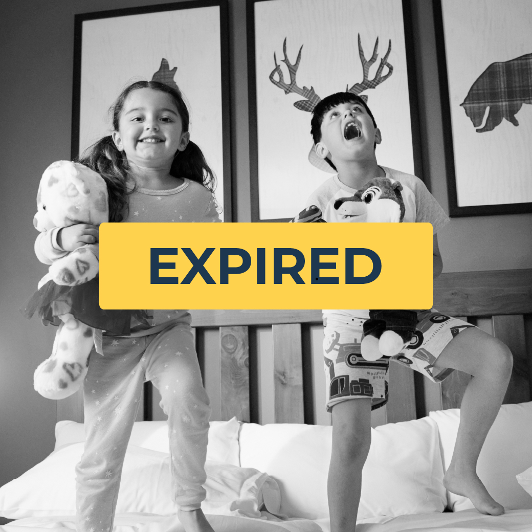 kids dancing on bed holding plush toys