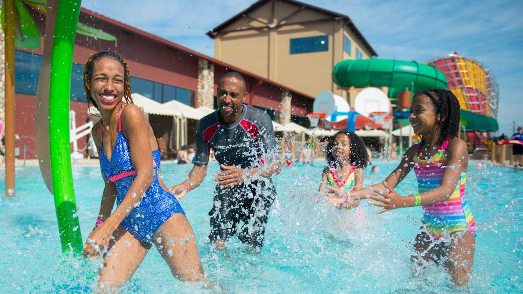 Family enjoying an outdoor water park at Great Wolf Lodge