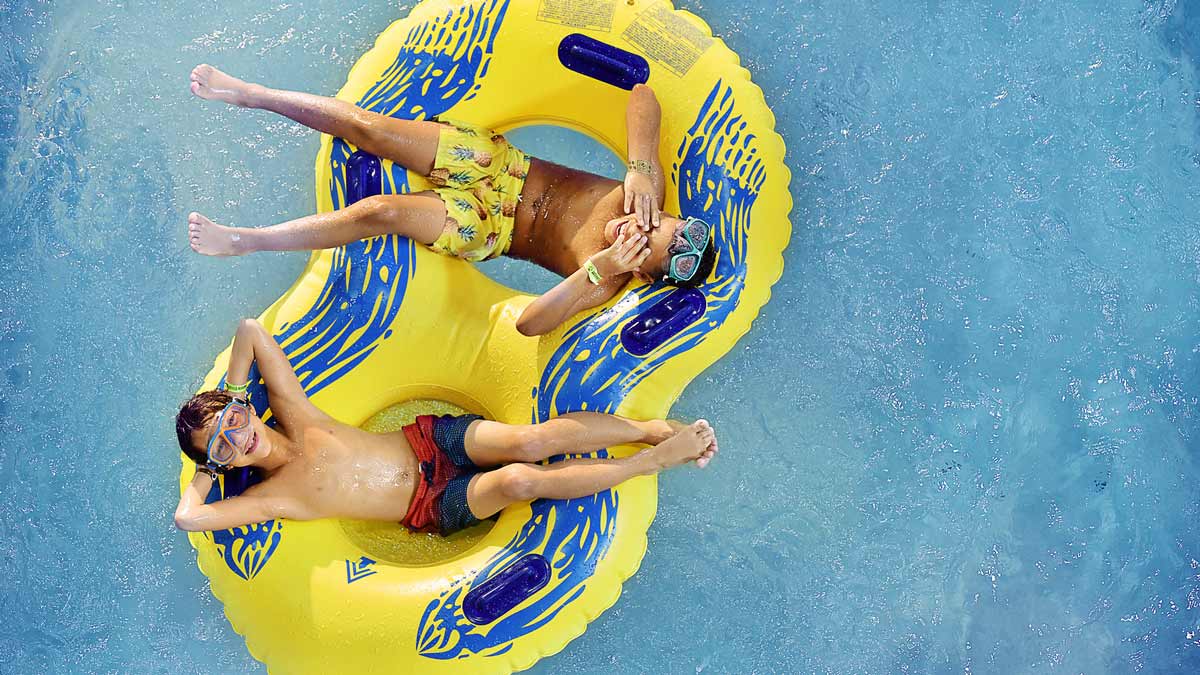 Two boys relaxing in a tube in the lazy river