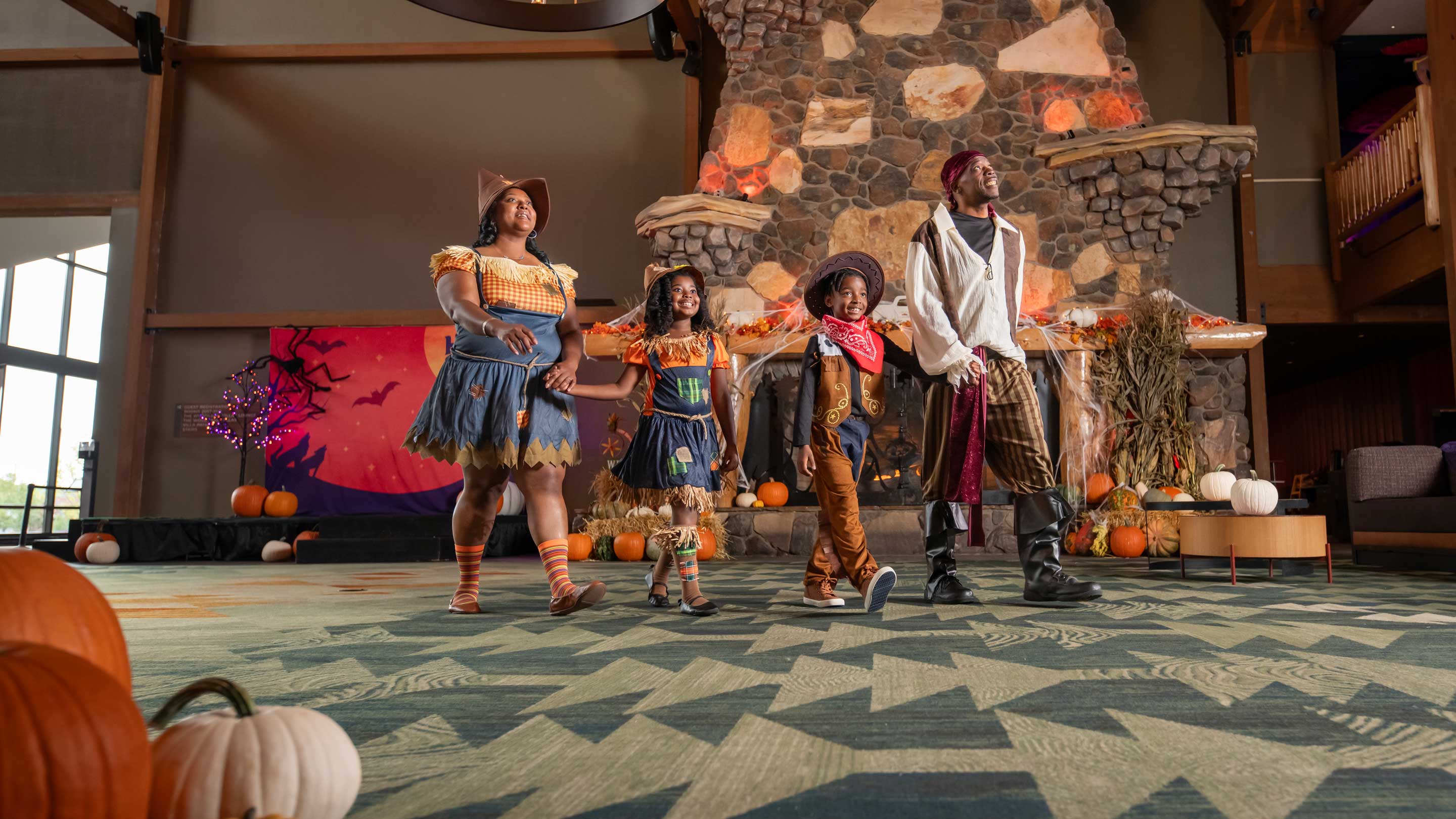 family wearing halloween costumes walking in the lobby