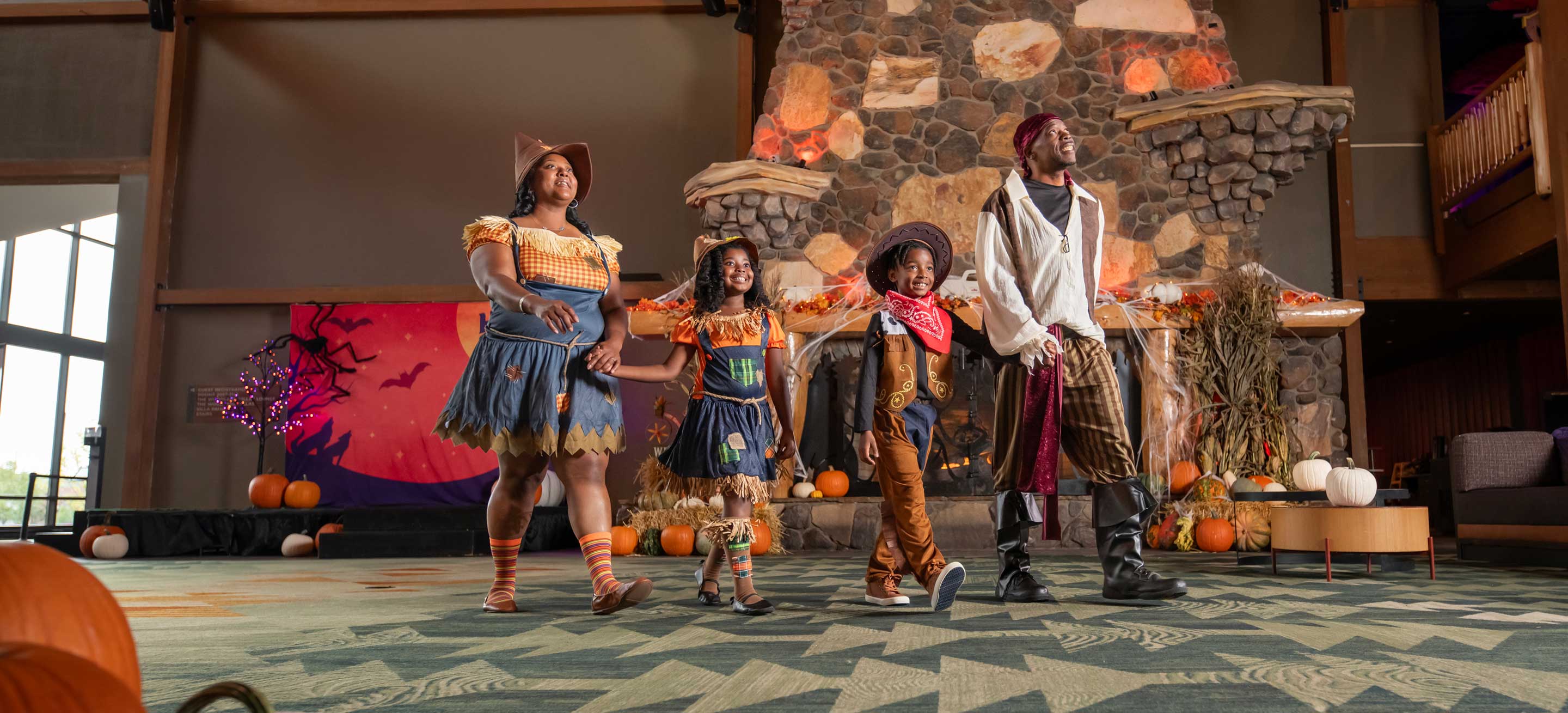 family wearing halloween costumes walking in the lobby