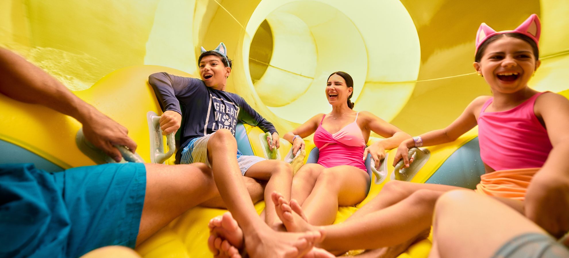 A family riding on a large tube going down a water slide