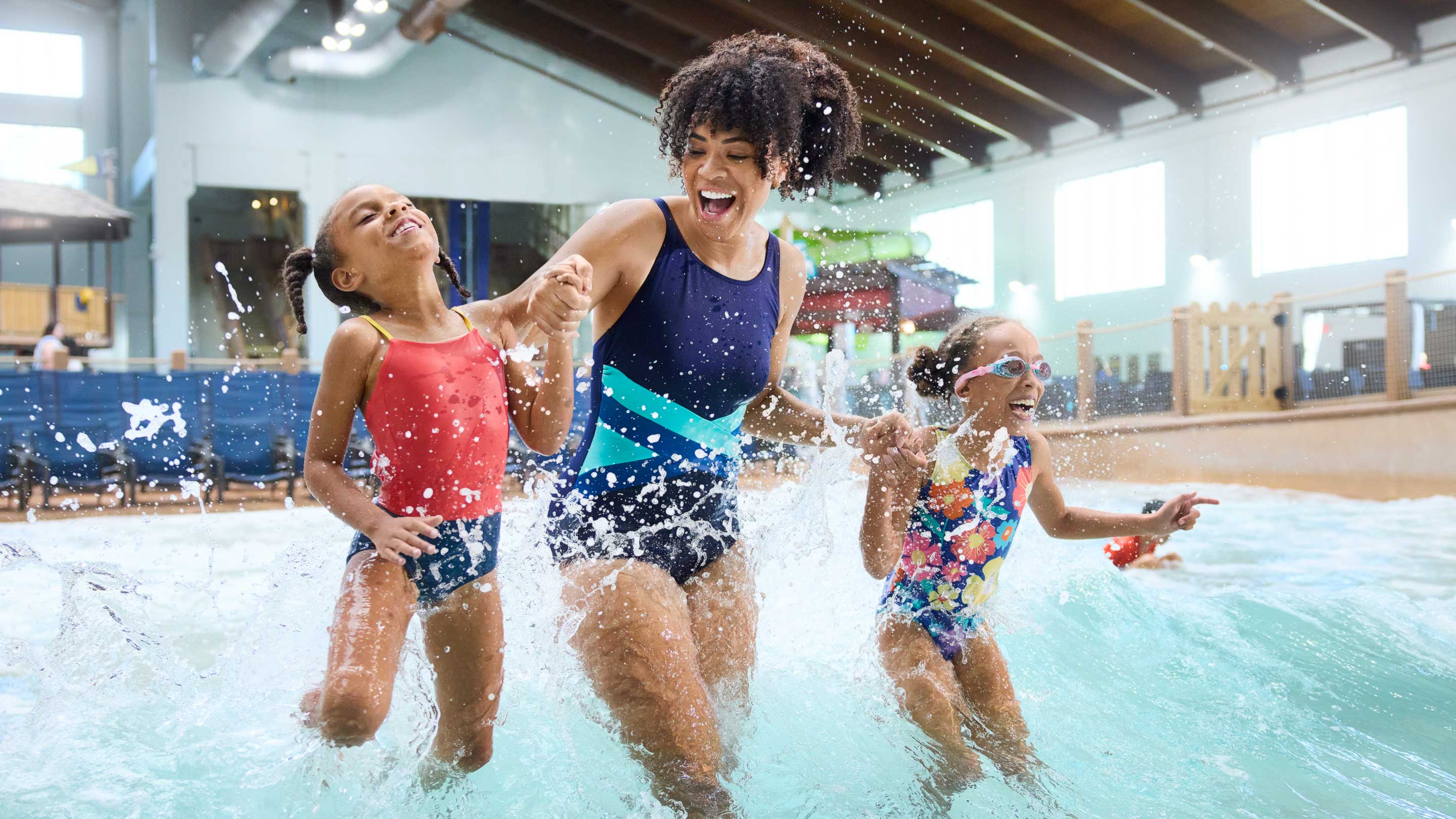 mother and daughters having fun in a wave pool