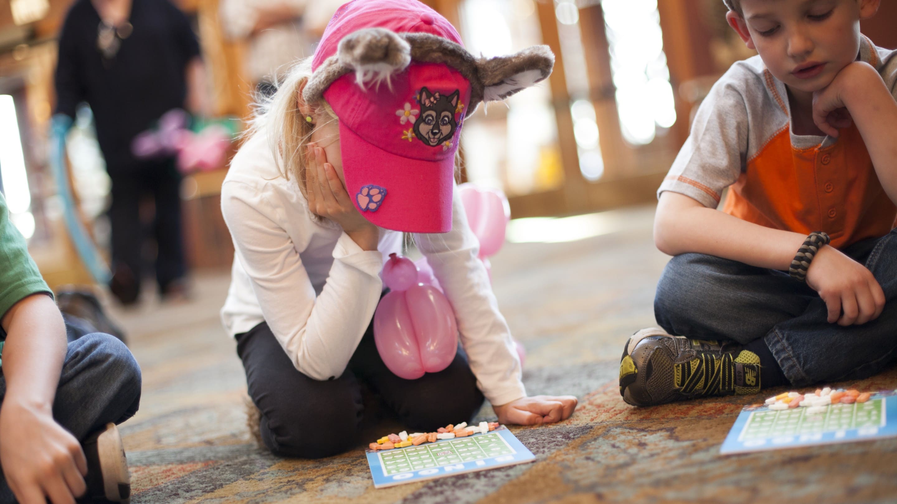 Kids focusing on their Bingo card to strike the numbers