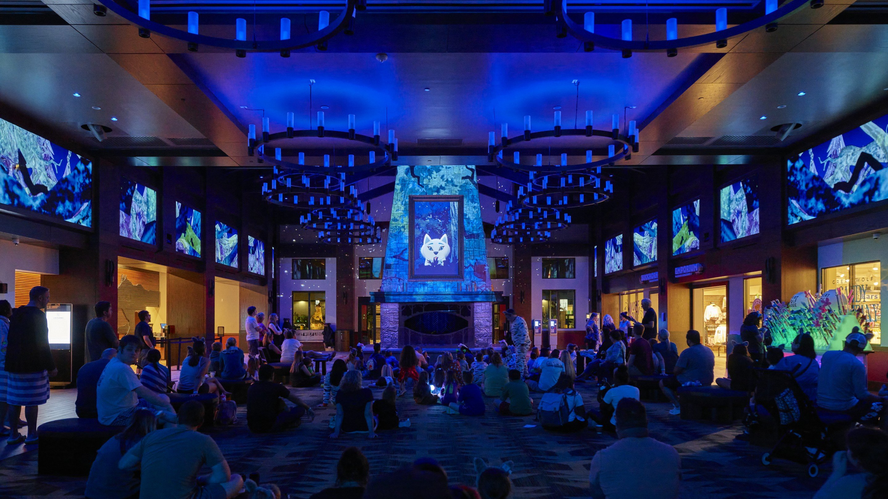 Families enjoy magical animated storytime with blue-lit fireplace