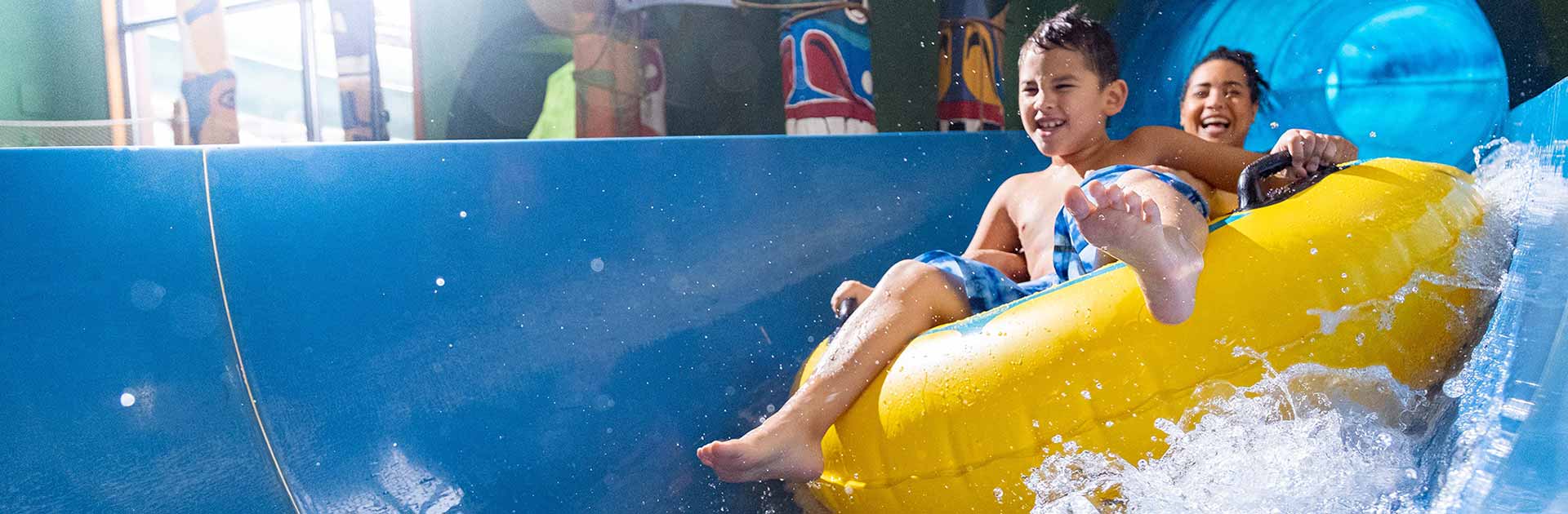 Mother and son having fun riding the tube