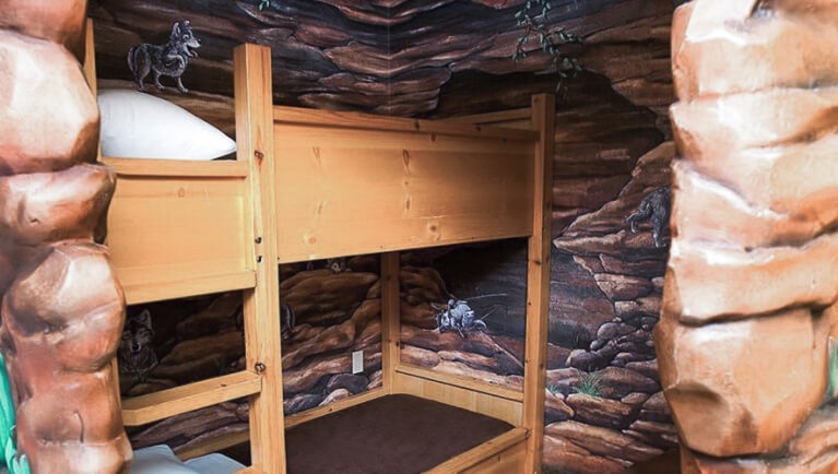 The bunk beds in the indoor cave of the Wolf Den Suite