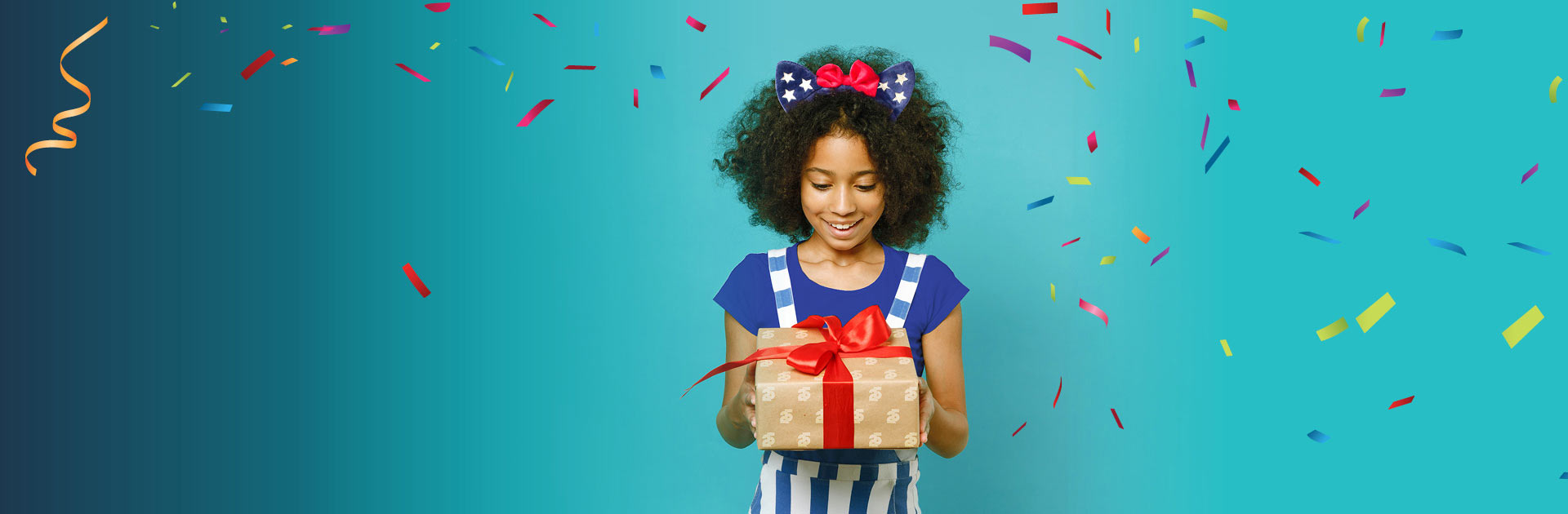 girl holding gift with confetti falling
