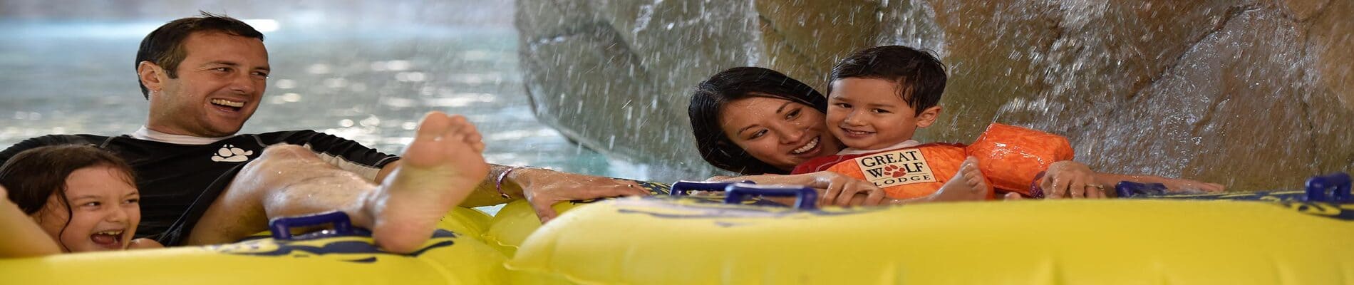 family of four riding the lazy river