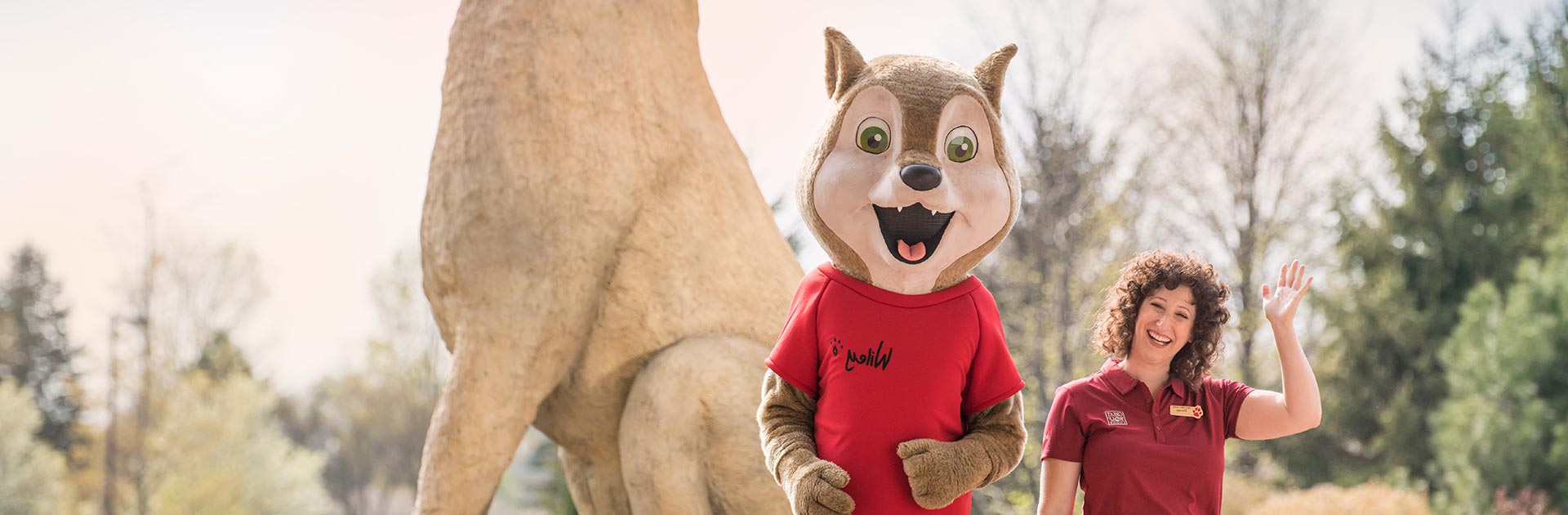 Wiley and staff member greeting a family