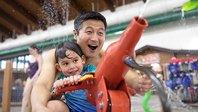 Dad with son in water park