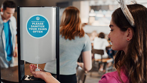 kid sanitizing her hands