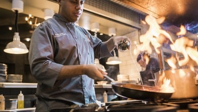 A chef preparing delicious food at Wood Fired Grill at Great Wolf Lodge indoor water park and resort.