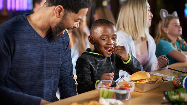 A family enjoys the food at Buckets Incredible Craveables at Great Wolf Lodge indoor water park and resort.
