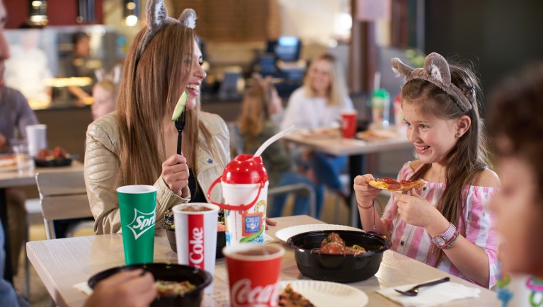 A family enjoying a meal at Hungry As A Wolf at Great Wolf Lodge indoor water park and resort.