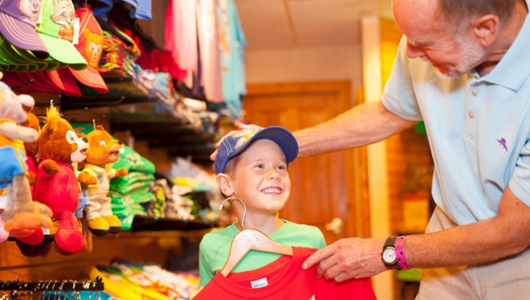 A grandfather and grandson shop for a shirt 