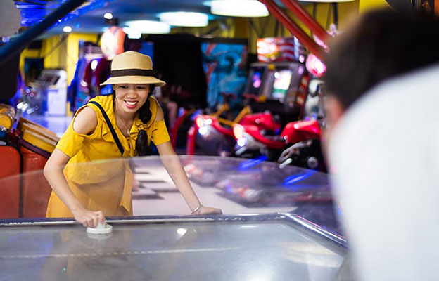 Woman playing games at arcade center