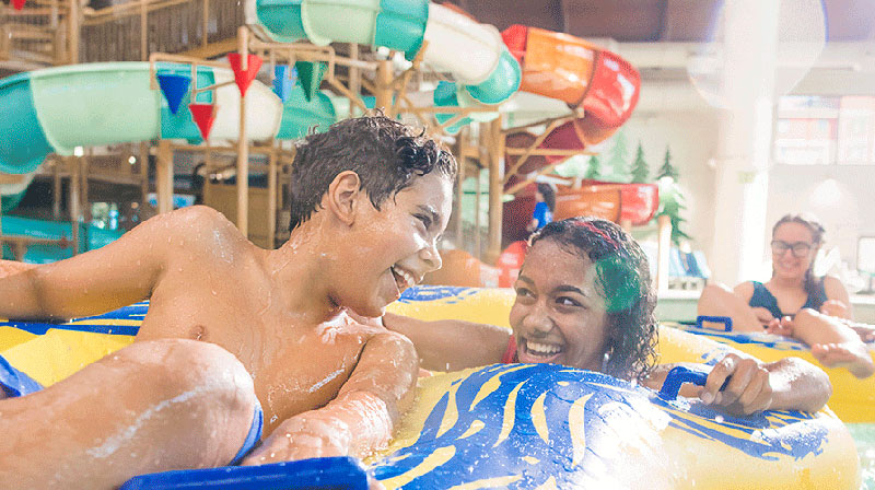 Three kids on a float in Great Wolf Lodge Indoor waterpark 