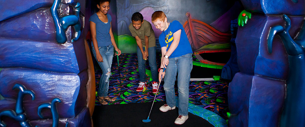 Kids play mini-golf