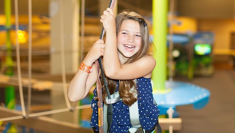 A girl climbs a rope