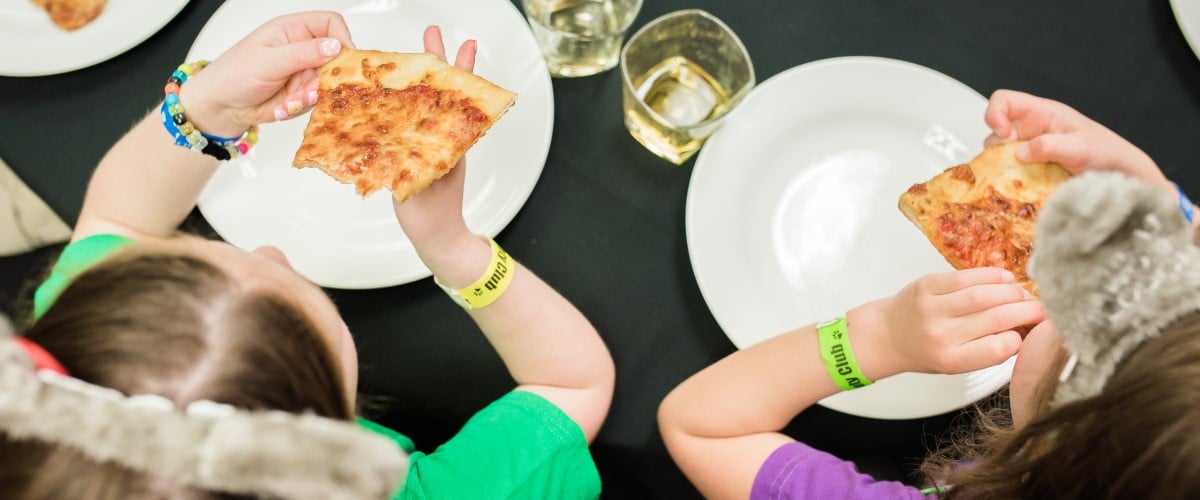 Children enjoying pizza and soda at great wolf lodge