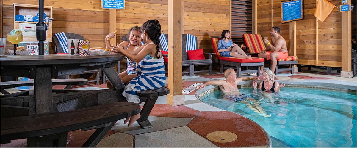 A family relaxes in a cabana at Great Wolf Lodge indoor water park and resort.
