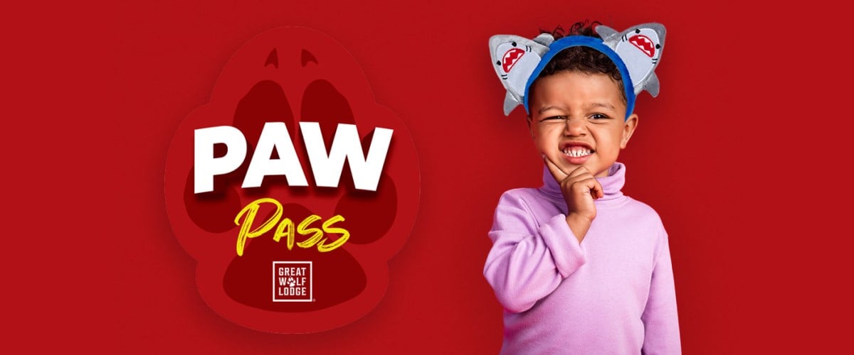 logo of paw pass along with a kid wearing shark ears