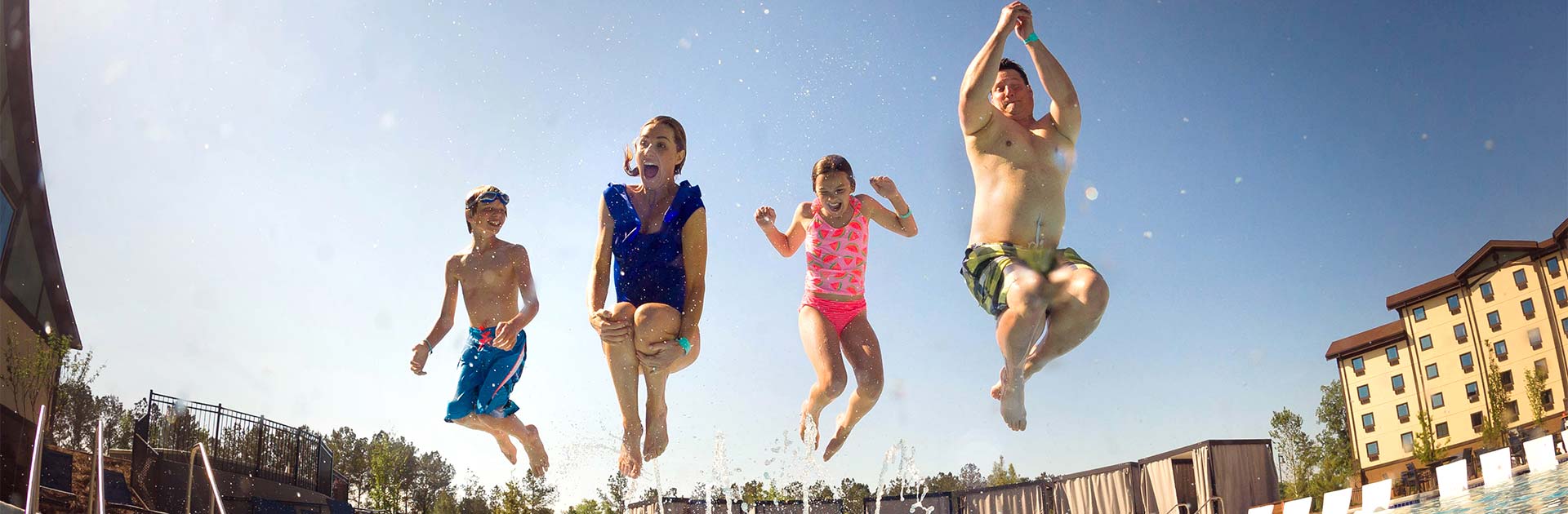 Family with Early Access jumping into the water