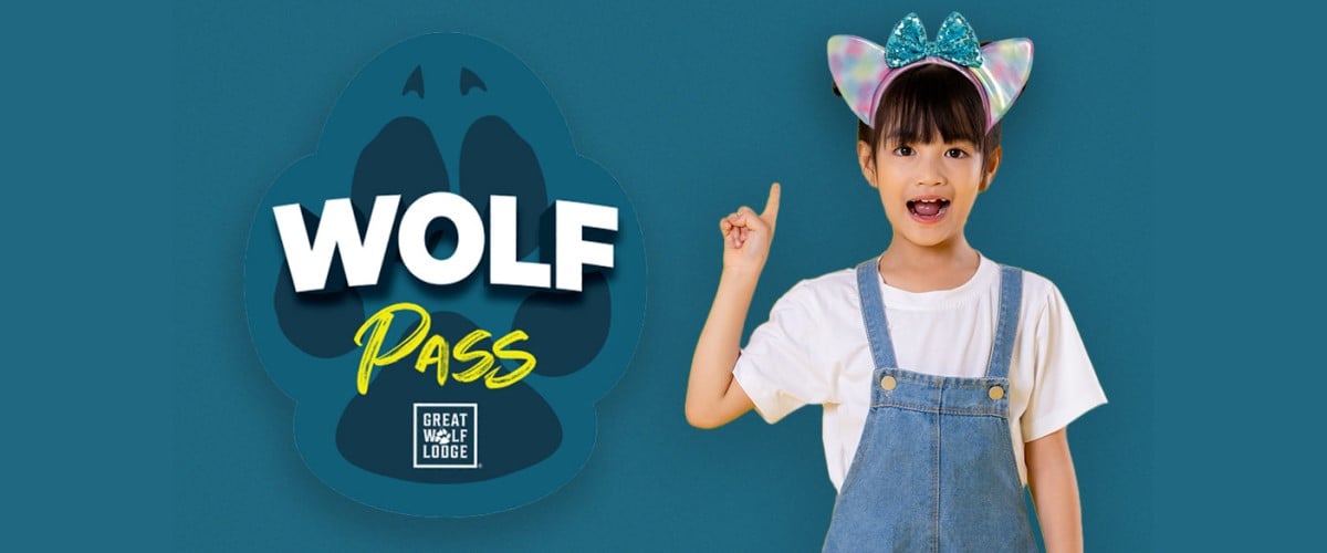 a girl smiles with wolf pass logo